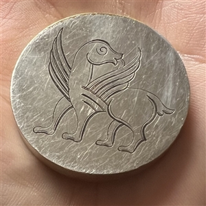 Fabulous creature on metal button.