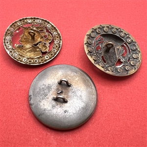 Three brass buttons of famous people’s heads.