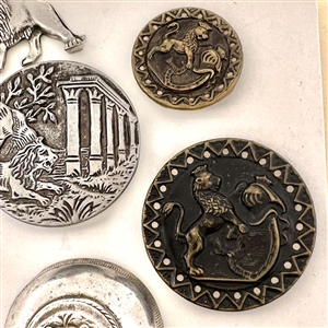 Six assorted metal buttons of lions.