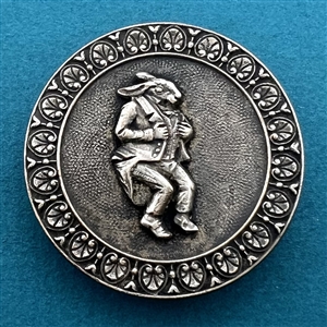 Silvered brass button of a rabbit in pants and suit jacket.