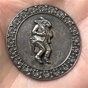 Silvered brass button of a rabbit in pants and suit jacket.