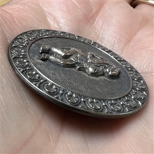 Silvered brass button of a rabbit in pants and suit jacket.
