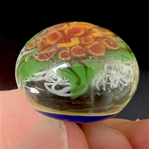 Seven assorted glass studio paperweight buttons.