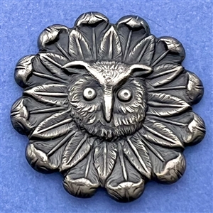 Silvered brass button of an owl face in a daisy.