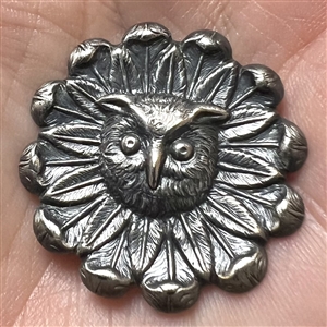 Silvered brass button of an owl face in a daisy.