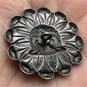 Silvered brass button of an owl face in a daisy.