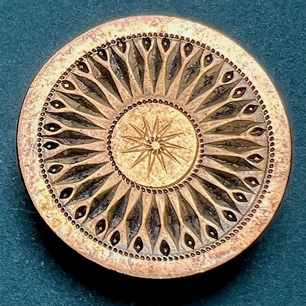 An 18th c. Heavily chased copper Colonial button of a sunburst.