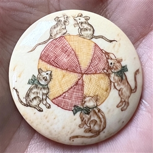 Kittens going after mice natural material button.