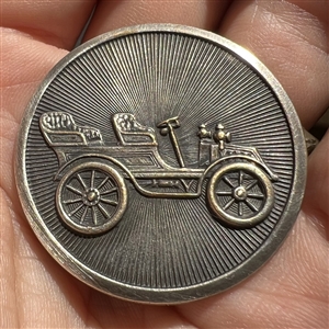 Silvered brass button of early automobile.