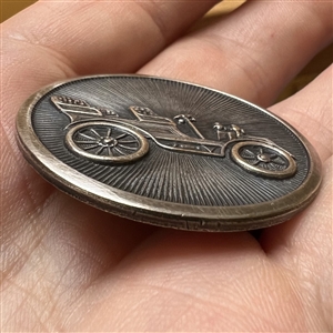 Silvered brass button of early automobile.