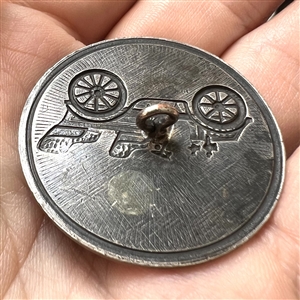 Silvered brass button of early automobile.