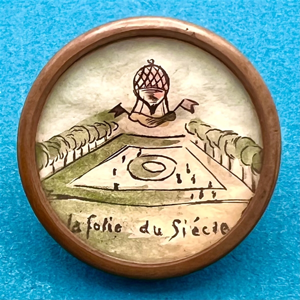 Hot air balloon with verbal - ink and paint on paper under glass button.