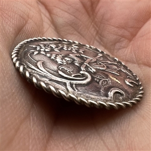 Hallmarked silver button of a musician playing.