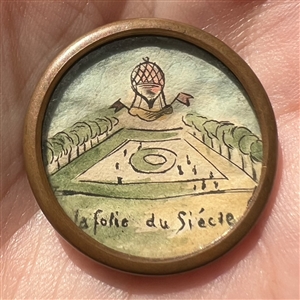 Hot air balloon with verbal - ink and paint on paper under glass button.