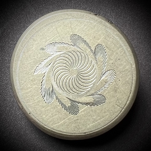 An 18th c. Tombac button with central spiral design.