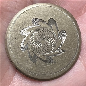An 18th c. Tombac button with central spiral design.