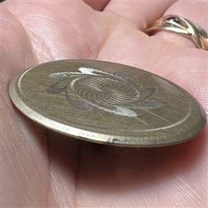 An 18th c. Tombac button with central spiral design.