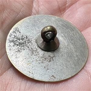 An 18th c. Tombac button with central spiral design.