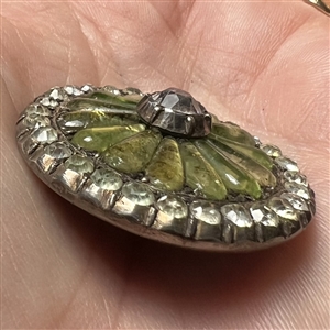 A 19th c. iridescent chartreuse glass set in metal button with faceted pastes.