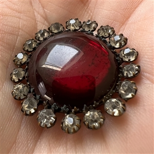 A 19th c. Ruby glass set in metal button.