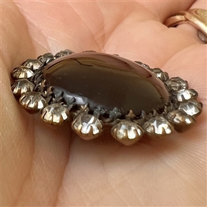 A 19th c. Ruby glass set in metal button.