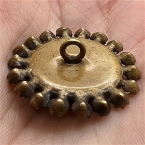 A 19th c. Ruby glass set in metal button.