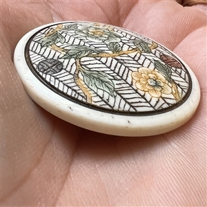 Flowers growing on trellis natural material button.