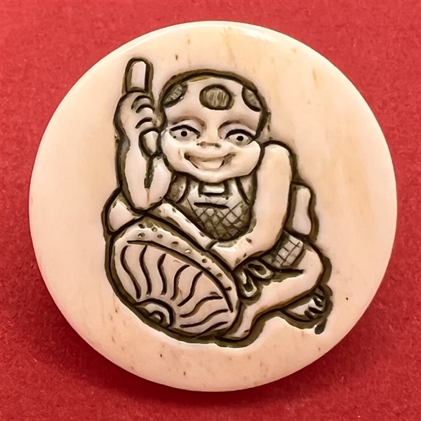 Child playing a drum natural material button.