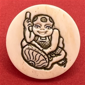 Child playing a drum natural material button.