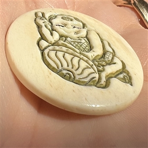 Child playing a drum natural material button.