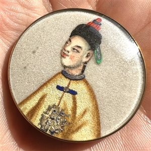 Painting on fabric button of an Asian man.