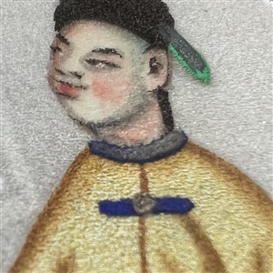 Painting on fabric button of an Asian man.