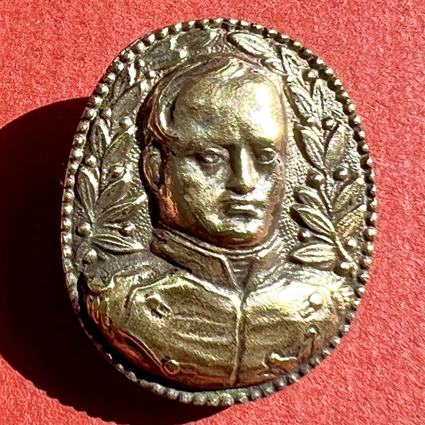 Cast white metal button of Napoleon.