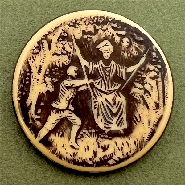 Large ivoroid “tight top” button of a man pushing a woman on a swing.