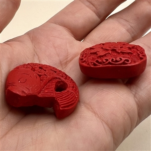 Two modern cinnabar buttons.