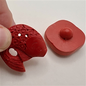 Two modern cinnabar buttons.