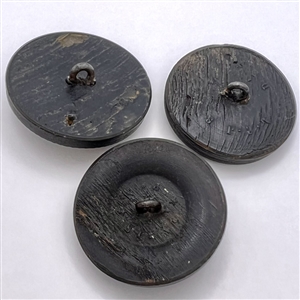 Three molded horn buttons of heads.