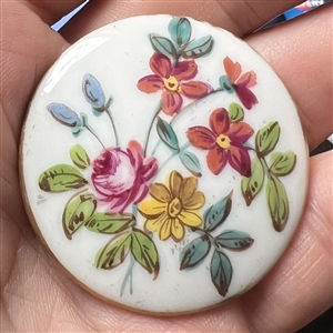 Porcelain button with floral design.