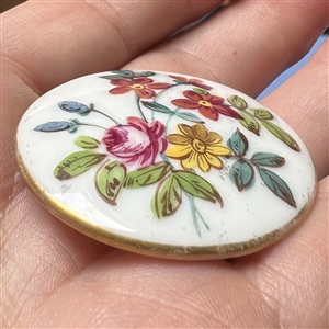 Porcelain button with floral design.