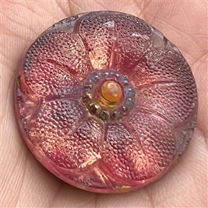 Lacy-type glass button of a flower.