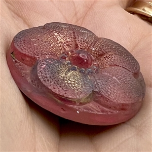 Lacy-type glass button of a flower.