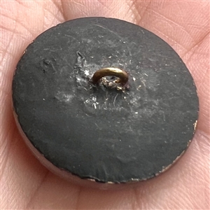 Lacy-type glass button of a flower.