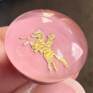 John Gooderham pink paperweight with gold foil horse and rider glass studio button.