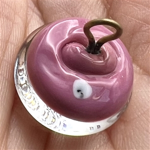 John Gooderham pink paperweight with gold foil horse and rider glass studio button.