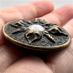 Imitation fire opal set in metal button with leaves. 