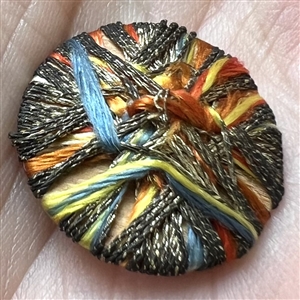 Colorful Death’s head fabric and bullion threads button.