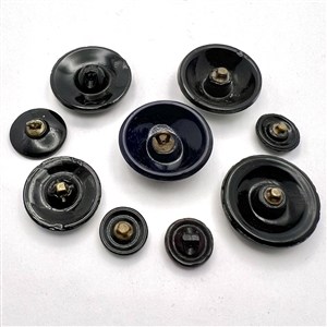 Nine assorted black glass imitation fabric buttons.