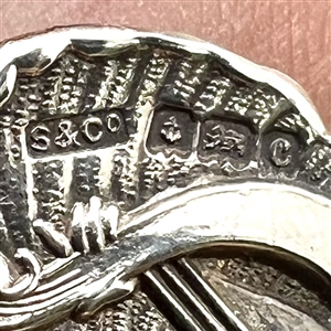 Hallmarked silver button of a “muse of music.