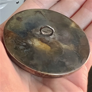 Ceramic button of two cherubs.