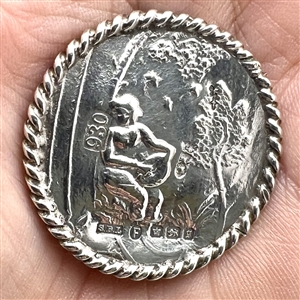 Hallmarked silver button of man playing an instrument in a garden.